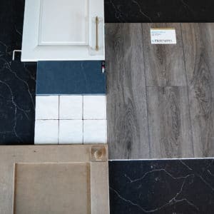 mood board with barn wood flooring, irish cream cabinets, soapstone charcoal countertops, white shimmering tiles, and maple cabinets up top
