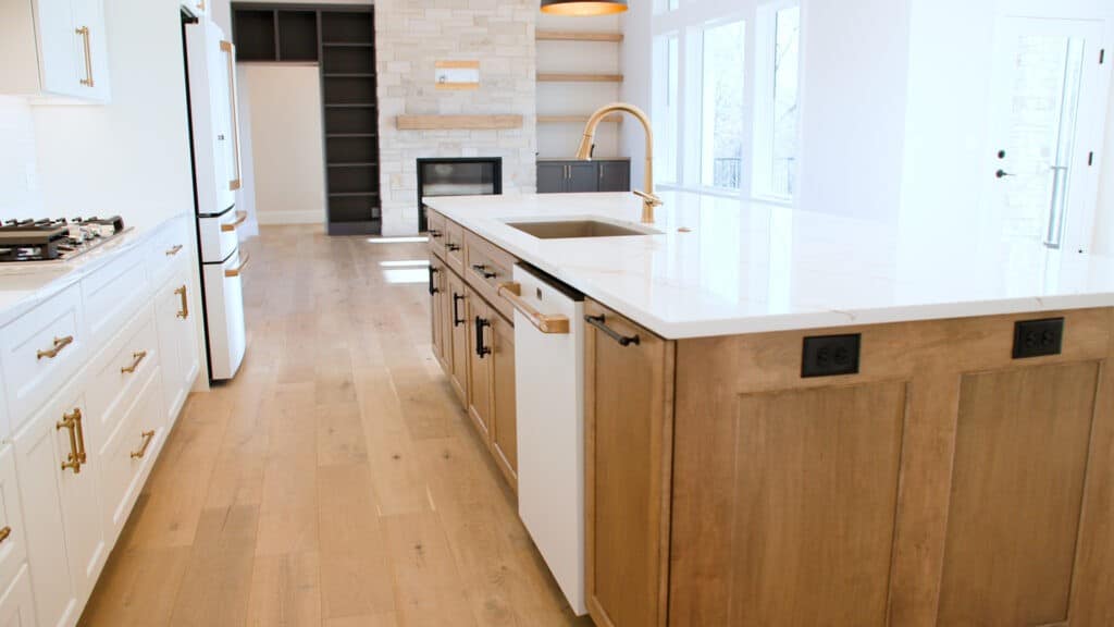 new construction kitchen with hardwood floors and white quartz countertops